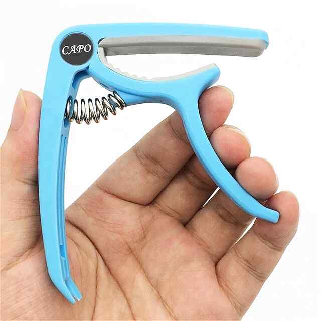 Каподастр для гітари ABS-пластик блакитний, вага 70г, розмір 9.5*18.5см. Універсальний та портативний.