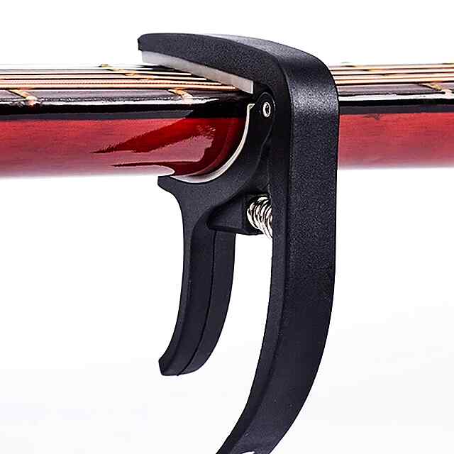 Каподастр для гітари – Зміна тональності, компактний та легкий. Чорний ABS-пластик, універсальний, зручний. Доставка по Україні. - 1 фото товару